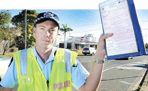 Constable Michael Hamilton from Hervey Bay police station with a traffic infringement notice. Constable Michael Hamilton from Hervey Bay police station with a traffic infringement notice.